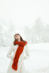A woman wearing a bright red scarf. A woman wearing a bright red scarf.