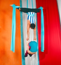 Two aerialists during a circus performance. Two aerialists during a circus performance.