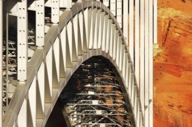 The girders of a suspension bridge form an arc. The girders of a suspension bridge form an arc.