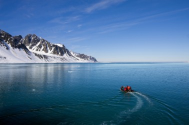 A boat travels the Arctic Ocean. A boat travels the Arctic Ocean.