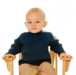 A child with his hands on the armrest of a chair. A child with his hands on the armrest of a chair.