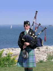 A man playing the bagpipes. A man playing the bagpipes.