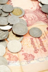 Thai baht banknotes and coins. Thai baht banknotes and coins.