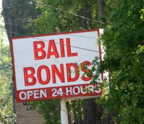 A sign outside a bail bonds office. A sign outside a bail bonds office.