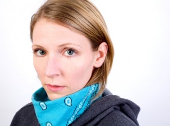 A woman wearing a bandanna around her neck. A woman wearing a bandanna around her neck.