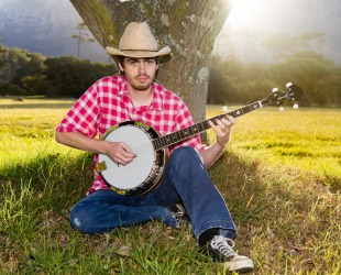 A man playing a banjo. A man playing a banjo.