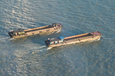Two barges on a river. Two barges on a river.