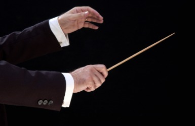 Conductor's hand holding his baton. Conductor's hand holding his baton.