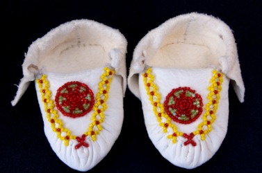 Beadwork on a pair of baby moccasins. Beadwork on a pair of baby moccasins.