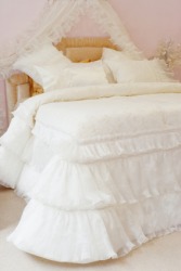 A bed made up with white bed linen or bedclothes. A bed made up with white bed linen or bedclothes.
