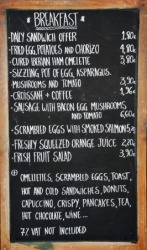 A restaurants bill of fare written on a black board. A restaurants bill of fare written on a black board.