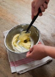 A woman blends cake ingredients together. A woman blends cake ingredients together.