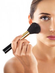A woman applying blusher. A woman applying blusher.