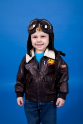 A child wearing a small version of a bomber jacket. A child wearing a small version of a bomber jacket.