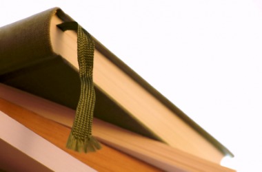 A book with a ribbon bookmark. A book with a ribbon bookmark.