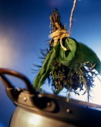 A bouquet garni about to be added to a pot. A bouquet garni about to be added to a pot.