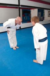 A young karate student bows to his Sensei A young karate student bows to his Sensei