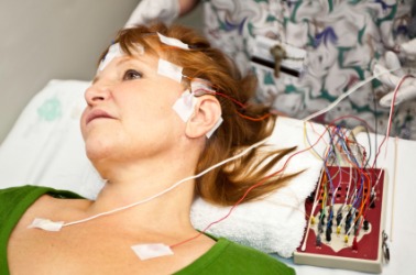 A woman having her brain waves measured. A woman having her brain waves measured.