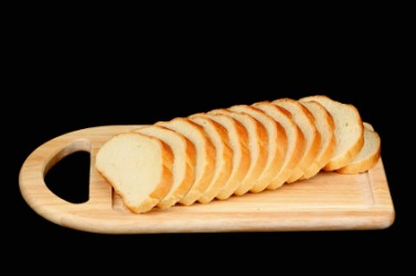 Slices of bread on a breadboard. Slices of bread on a breadboard.