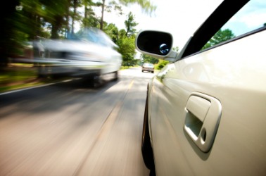 One car passes another at breakneck speed. One car passes another at breakneck speed.
