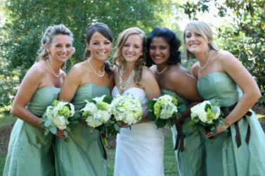 A bride posing with her bridesmaids. A bride posing with her bridesmaids.