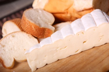 A wedge of brie cheese. A wedge of brie cheese.