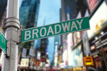 The Broadway street sign against the city lights. The Broadway street sign against the city lights.