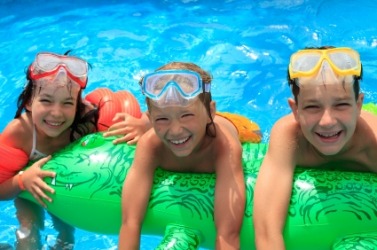 Children enjoying the buoyancy of their inflatable water toy. Children enjoying the buoyancy of their inflatable water toy.
