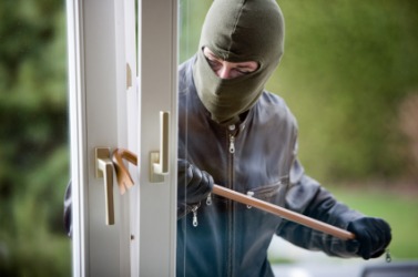 A man commiting a burglary. A man commiting a burglary.