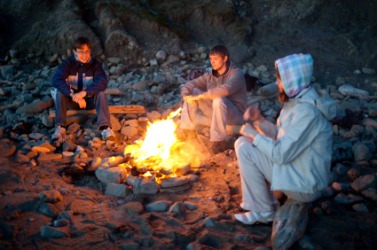 Campers sitting around a campfire. Campers sitting around a campfire.