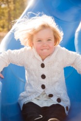 A little girl wearing a white cardigan. A little girl wearing a white cardigan.