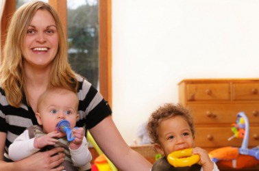 This woman is acting as caregiver to these two children. This woman is acting as caregiver to these two children.