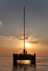 A catamaran at sunset. A catamaran at sunset.