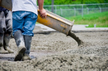 Cement being poured at a construction site. Cement being poured at a construction site.