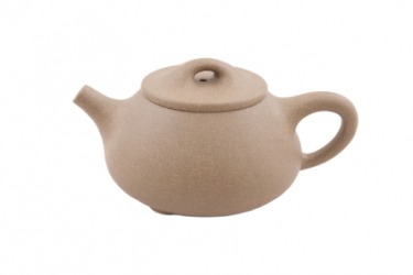A beige ceramic teapot. A beige ceramic teapot.