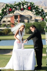 A couple participating in the sand ceremony at their wedding. A couple participating in the sand ceremony at their wedding.