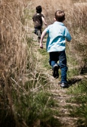 One little boy chasing another. One little boy chasing another.