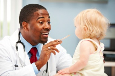 A little girl gets a checkup from her doctor. A little girl gets a checkup from her doctor.