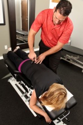 A chiropractor gives a woman an adjustment. A chiropractor gives a woman an adjustment.