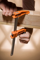 Two boards being held together by wood clamps. Two boards being held together by wood clamps.