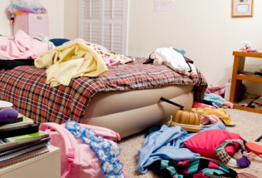 A bedroom with lots of clutter. A bedroom with lots of clutter.