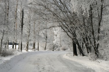 It would be very cold walking down this snowy road. It would be very cold walking down this snowy road.
