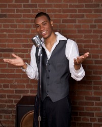 A comedian performing in a nightclub. A comedian performing in a nightclub.