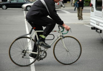 A commuter on a bicycle. A commuter on a bicycle.