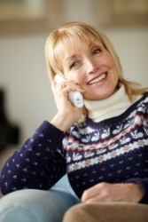 A woman converses on the telephone. A woman converses on the telephone.