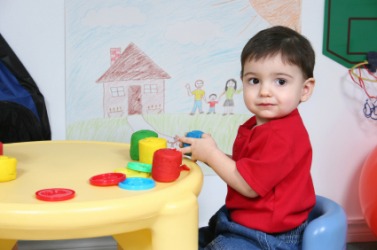 A child at a day nursery. A child at a day nursery.