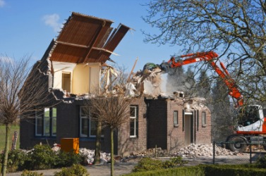 A house being demolished. A house being demolished.