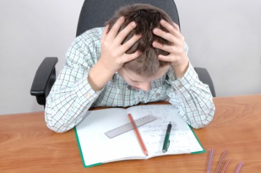 A child struggles with a difficult math problem. A child struggles with a difficult math problem.