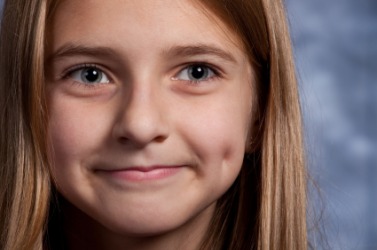 A girl with a dimple in her cheek. A girl with a dimple in her cheek.
