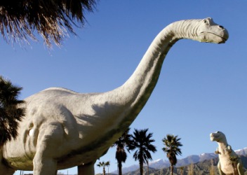 A statue of a dinosaur or dino. A statue of a dinosaur or dino.
